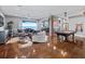 Large game room with pool table, comfortable seating, and water views at 12943 Se Sunset Harbor Rd, Weirsdale, FL 32195