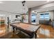 Basement game room with a pool table and access to a waterfront patio at 12943 Se Sunset Harbor Rd, Weirsdale, FL 32195