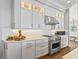Modern kitchen with stainless steel appliances and white shaker cabinets at 12943 Se Sunset Harbor Rd, Weirsdale, FL 32195
