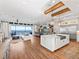 Open concept kitchen with island, stainless steel appliances, and water views at 12943 Se Sunset Harbor Rd, Weirsdale, FL 32195