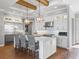 Modern kitchen with island, stainless steel appliances, and white cabinets at 12943 Se Sunset Harbor Rd, Weirsdale, FL 32195