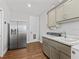 Convenient laundry room with a sink and storage at 12943 Se Sunset Harbor Rd, Weirsdale, FL 32195