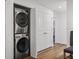 Convenient laundry room with stacked washer and dryer at 12943 Se Sunset Harbor Rd, Weirsdale, FL 32195