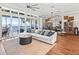 Spacious living room with water views, comfortable seating, and hardwood floors at 12943 Se Sunset Harbor Rd, Weirsdale, FL 32195