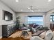 Comfortable living room with a sectional sofa, large TV, and water views at 12943 Se Sunset Harbor Rd, Weirsdale, FL 32195