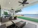 Covered patio overlooking the lake with seating and fire pit at 12943 Se Sunset Harbor Rd, Weirsdale, FL 32195