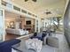 Relaxing screened porch with outdoor furniture and view of nature at 12943 Se Sunset Harbor Rd, Weirsdale, FL 32195