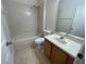 Cozy bathroom featuring a combination tub and shower unit and a single sink vanity at 510 Coventry Rd, Davenport, FL 33897