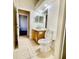Hall bathroom with a single sink vanity, commode and a tile floor at 510 Coventry Rd, Davenport, FL 33897