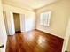 A cozy bedroom with hardwood floors, closet, and natural light from the window at 510 Coventry Rd, Davenport, FL 33897