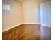 A sunlit bedroom with laminate floors and a sliding glass door at 510 Coventry Rd, Davenport, FL 33897