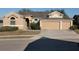 Tan house with three-car garage and manicured lawn at 510 Coventry Rd, Davenport, FL 33897