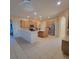 Spacious kitchen featuring wood cabinets, an island, stainless steel appliances, tile backsplash and flooring and lots of room at 510 Coventry Rd, Davenport, FL 33897