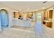 Spacious kitchen featuring wood cabinets, an island, stainless steel appliances, tile backsplash and flooring and lots of room at 510 Coventry Rd, Davenport, FL 33897