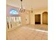 Open living room featuring tile flooring, an arched entryway, natural lighting and neutral paint to make the room bright at 510 Coventry Rd, Davenport, FL 33897