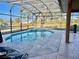 Screened-in pool featuring a jacuzzi and a scenic view of the outdoors, providing private relaxation and entertainment at 510 Coventry Rd, Davenport, FL 33897