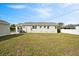 This backyard offers substantial room for leisure activities, with a detached garage complementing the open grassy expanse at 2814 Coventry Ave, Lakeland, FL 33803