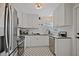 Well-lit kitchen with stainless steel appliances, subway tile, and black and white floors at 2814 Coventry Ave, Lakeland, FL 33803