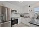 Modern kitchen with white cabinets, stainless steel appliances, and stylish backsplash at 2814 Coventry Ave, Lakeland, FL 33803