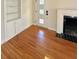 Living room with hardwood floors, built-in shelving, and fireplace at 2814 Coventry Ave, Lakeland, FL 33803