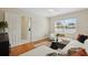 Cozy living room with a white sectional sofa, large windows, and doorway to bathroom at 2814 Coventry Ave, Lakeland, FL 33803