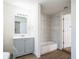 Modern bathroom with gray vanity and a white bathtub at 1316 Hackett St, Mount Dora, FL 32757