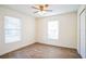 Spacious bedroom with wood-look floors and two large windows at 1316 Hackett St, Mount Dora, FL 32757