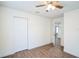 Bright bedroom with wood-look floors and ceiling fan at 1316 Hackett St, Mount Dora, FL 32757