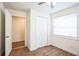 Bedroom with closet, wood-look flooring, and window at 1316 Hackett St, Mount Dora, FL 32757