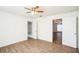 Bedroom with wood-look floors, ceiling fan, and en-suite bathroom at 1316 Hackett St, Mount Dora, FL 32757