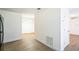 Clean and bright hallway with wood-look floors and access to other rooms at 1316 Hackett St, Mount Dora, FL 32757