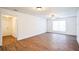 Bright living room with wood-look floors and large window at 1316 Hackett St, Mount Dora, FL 32757