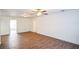 Large living room featuring wood-look floors and a ceiling fan at 1316 Hackett St, Mount Dora, FL 32757