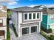 Modern two-story home with gray stone accents and two-car garage at 1544 Corolla Ct, Reunion, FL 34747