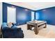Game room featuring a pool table, comfortable seating, and a stylish blue accent wall at 1544 Corolla Ct, Reunion, FL 34747