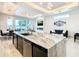 Open concept kitchen and living area with marble island and comfortable seating at 1544 Corolla Ct, Reunion, FL 34747