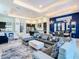 Open concept living room with sectional sofa and large windows at 1544 Corolla Ct, Reunion, FL 34747