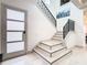 Modern staircase with gray and white marble tile and metal railing at 1544 Corolla Ct, Reunion, FL 34747