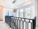 Modern staircase with black metal railing and marble flooring at 1544 Corolla Ct, Reunion, FL 34747