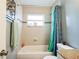 Bathroom with bathtub, shower, and teal shower curtain at 8115 Esperanza St, Orlando, FL 32817