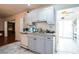 Kitchen with light grey cabinets and a view to backyard at 8115 Esperanza St, Orlando, FL 32817