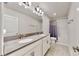 Double vanity bathroom with grey countertop and tub shower combo at 1457 Olympic Club Blvd, Champions Gate, FL 33896