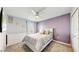 Light and airy bedroom with a double bed and purple walls at 1457 Olympic Club Blvd, Champions Gate, FL 33896