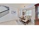 Spacious dining room with a wooden table, chandelier, and decorative hutch at 1457 Olympic Club Blvd, Champions Gate, FL 33896