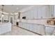 Modern kitchen with white cabinets and granite countertops at 1457 Olympic Club Blvd, Champions Gate, FL 33896