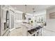 Modern kitchen with white cabinets, large island, and stainless steel appliances at 1457 Olympic Club Blvd, Champions Gate, FL 33896