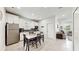 Modern kitchen with white cabinets, marble top table, and stainless steel appliances at 1457 Olympic Club Blvd, Champions Gate, FL 33896