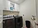 Bright laundry room with washer, dryer, and ample storage at 1457 Olympic Club Blvd, Champions Gate, FL 33896