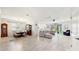 Open living space with a large sectional sofa and view to the dining room at 1457 Olympic Club Blvd, Champions Gate, FL 33896