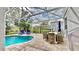 Relaxing pool and patio area with table and chairs at 1457 Olympic Club Blvd, Champions Gate, FL 33896